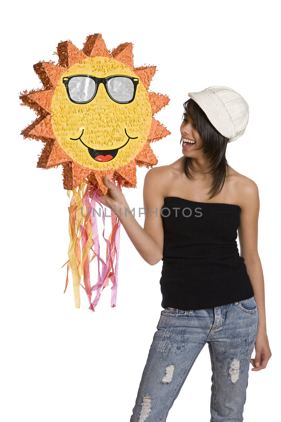 Teenage girl wearing a black tube top, knitted hat and jeans with holes holding a sunny pinata