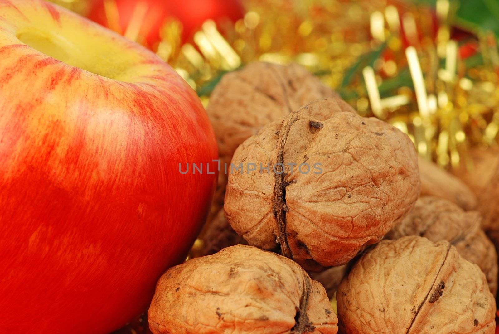 Christmas background - apple and nuts on gold ribbon