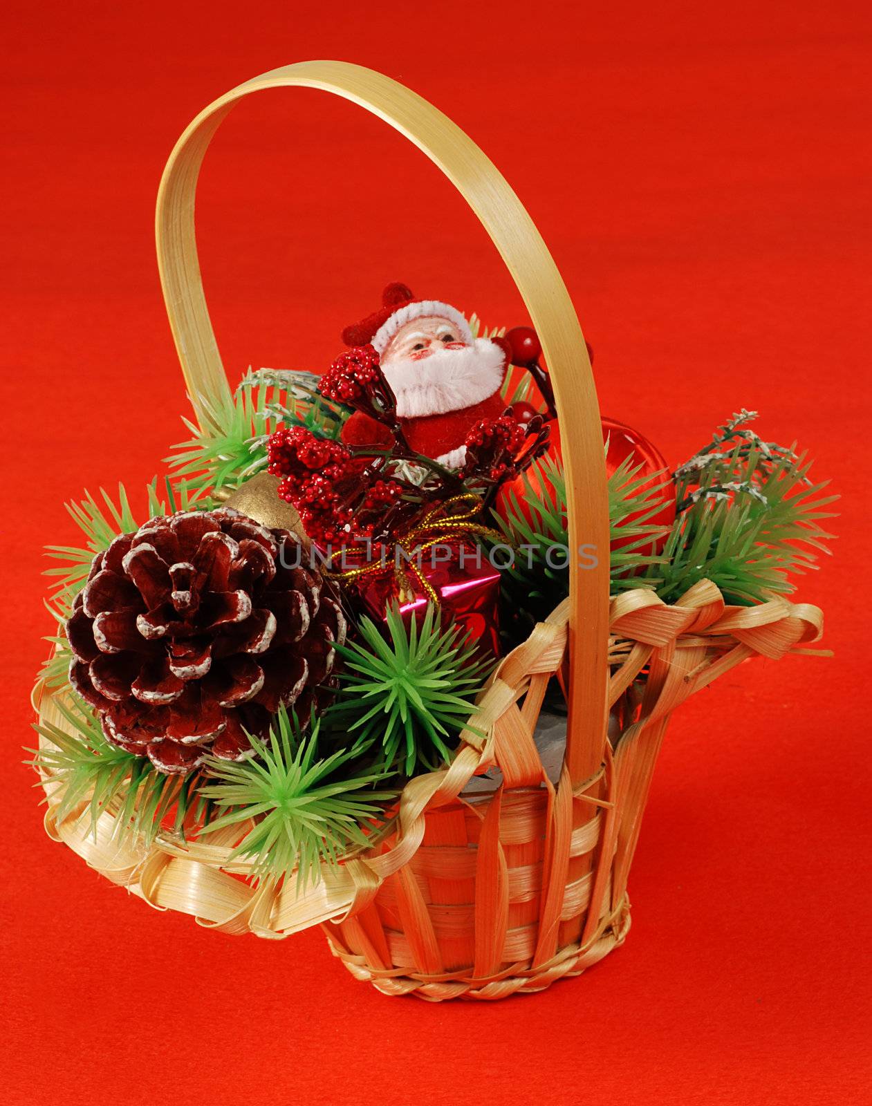 Basket with traditional christmas decorations - Santa and pine cone