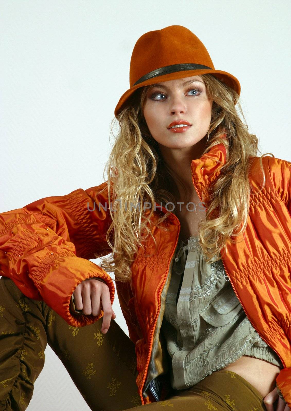 The beautiful young blonde in a red jacket and a hat