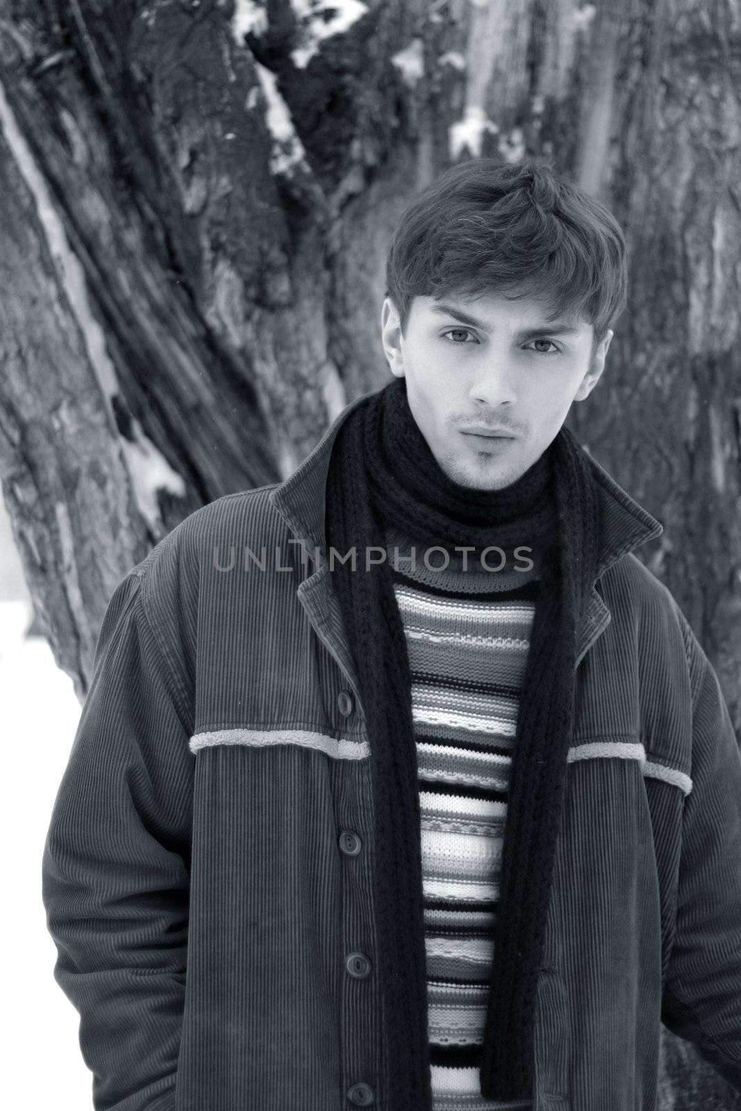 Portrait of the young man in the winter. b/w+blue tone