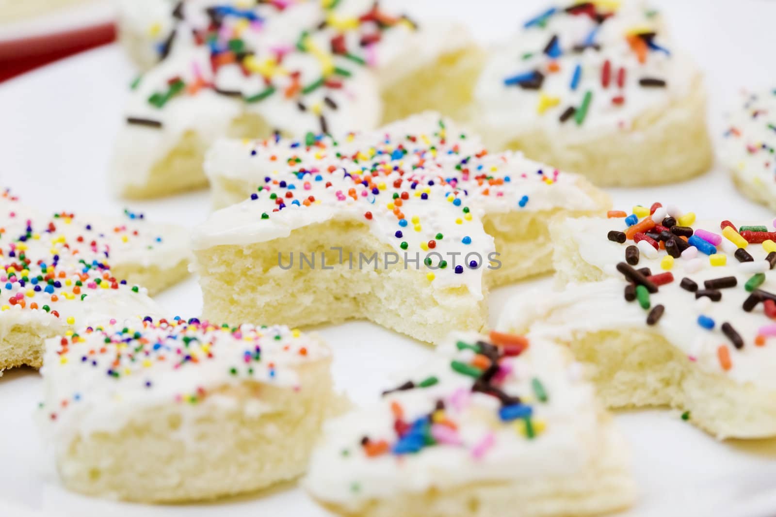 Frosted cake pieces with sprinkles, cut into star and heart shapes