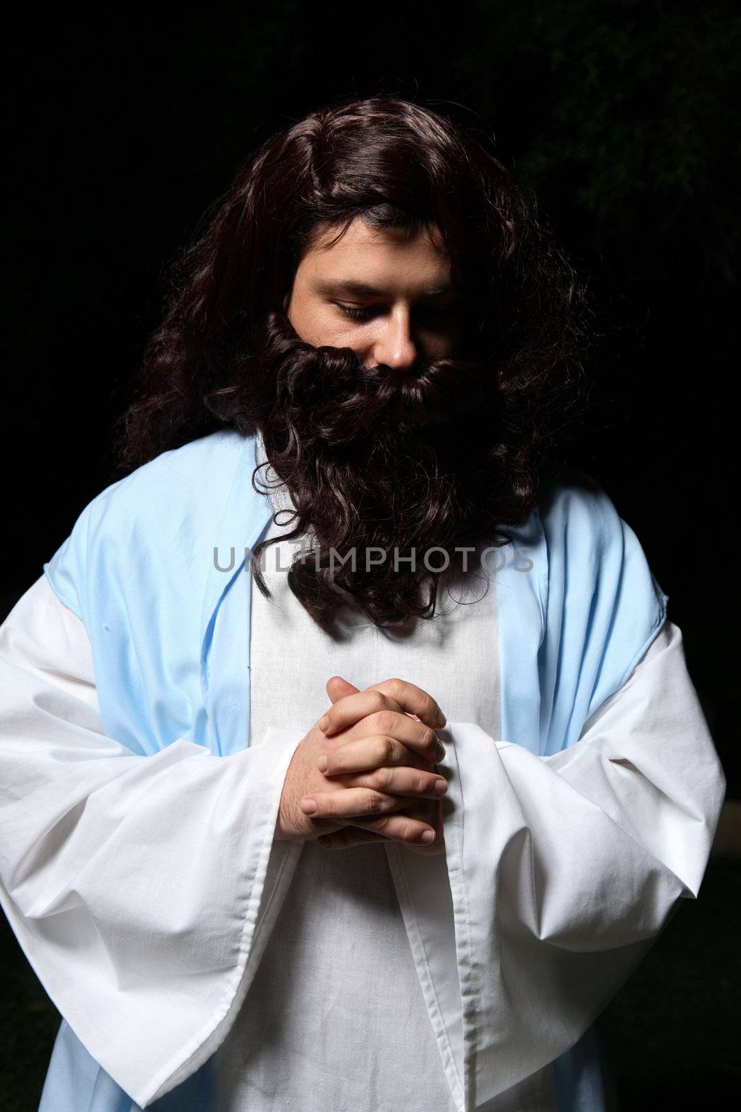 Biblical or middle eastern man head bowed and praying