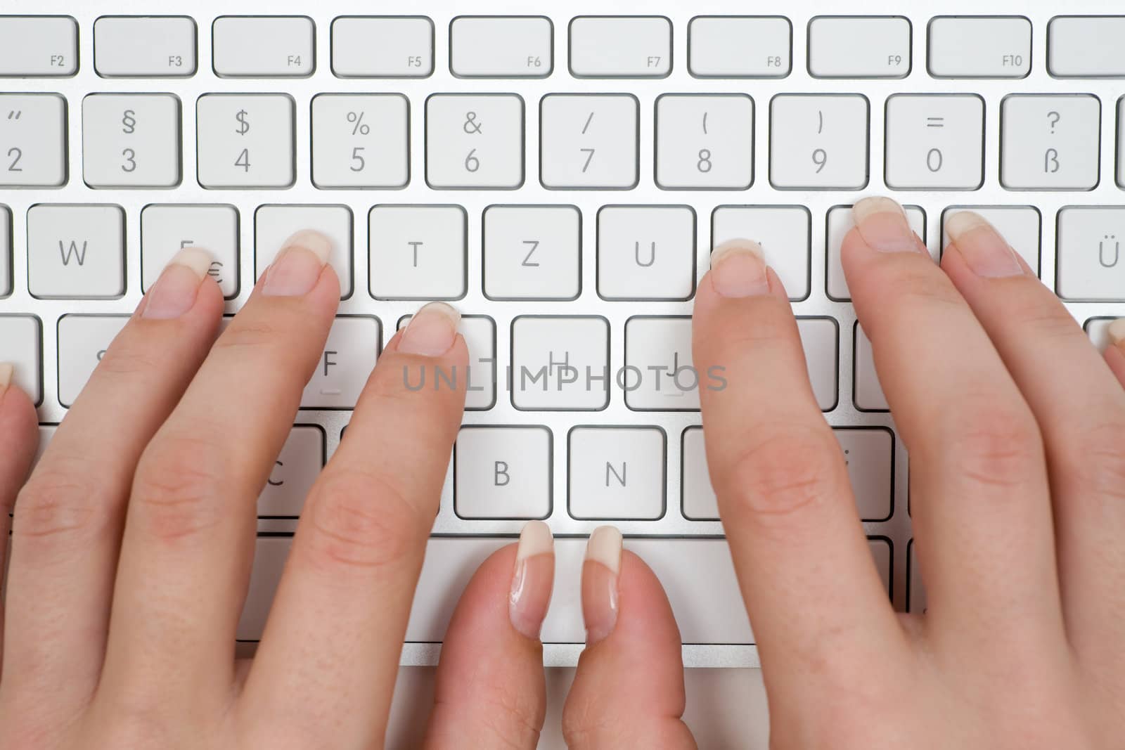 Female hands on a modern computer keyboard.