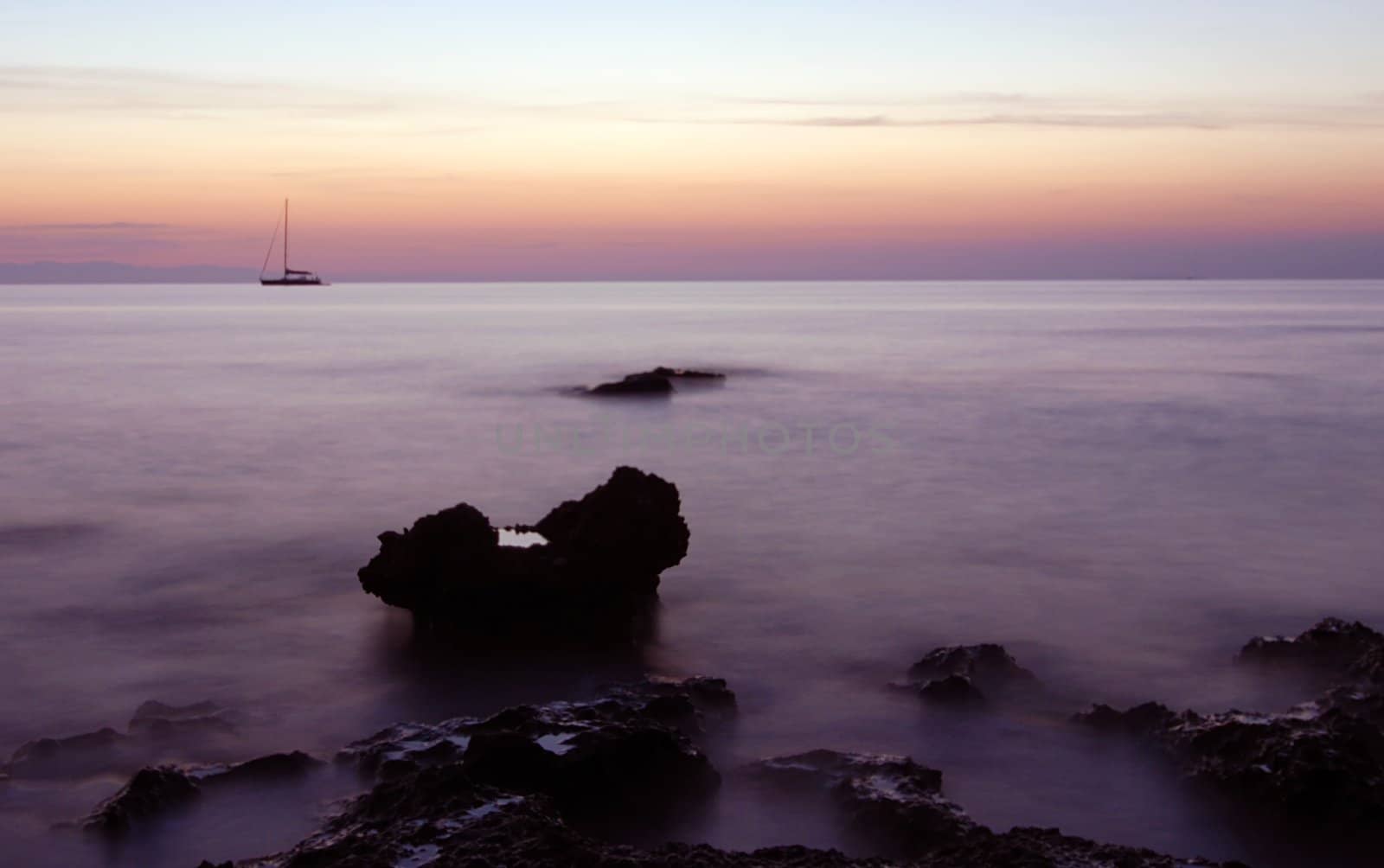 Boat and rock at sunrise by fyletto