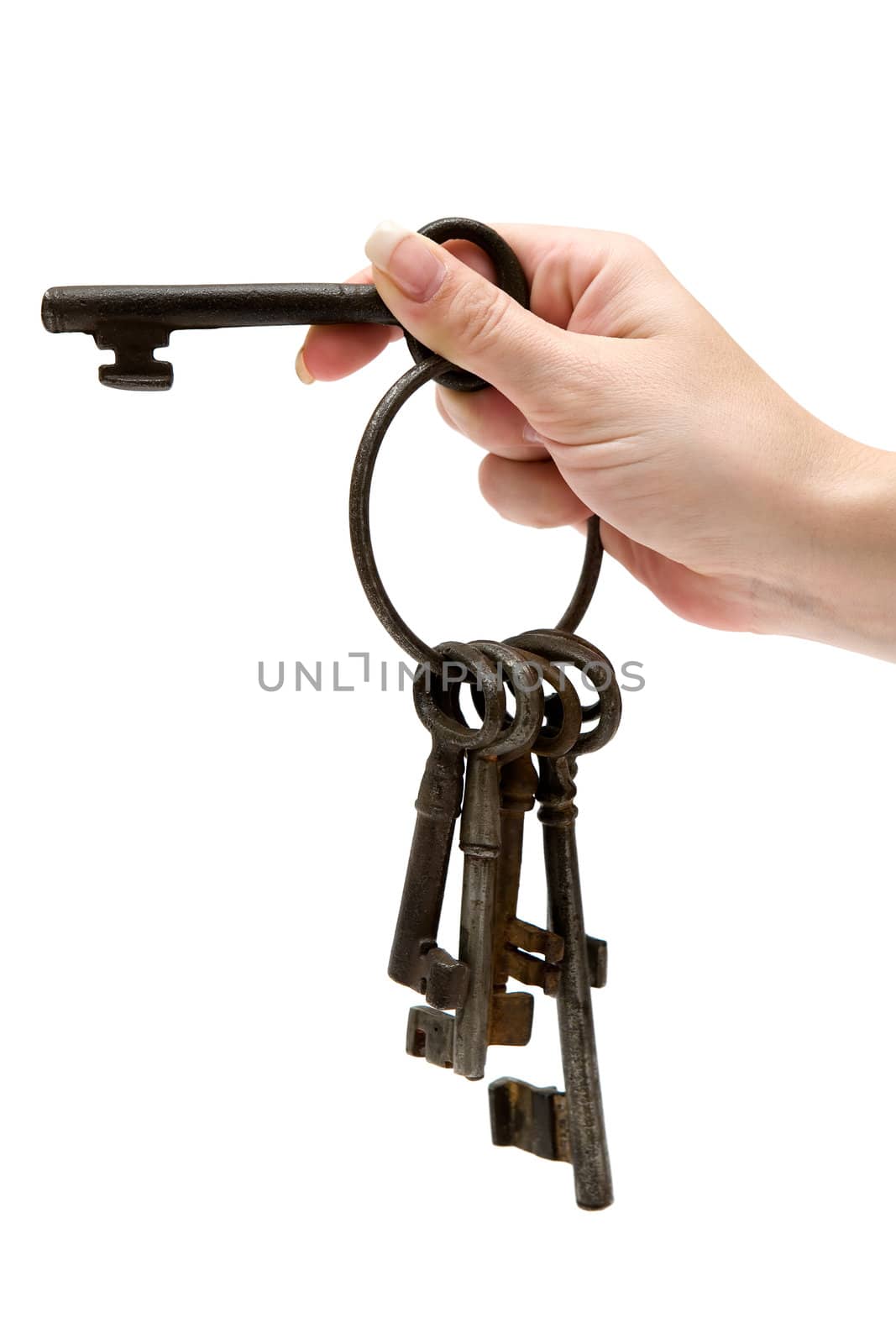 Female hand holding a bunch of rusty old keys. Isolated on a white background.