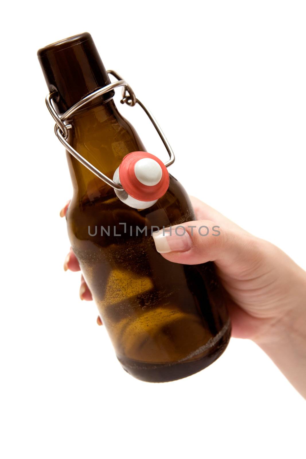 Female hand holding an opened beer bottle. Isolated on a white background.