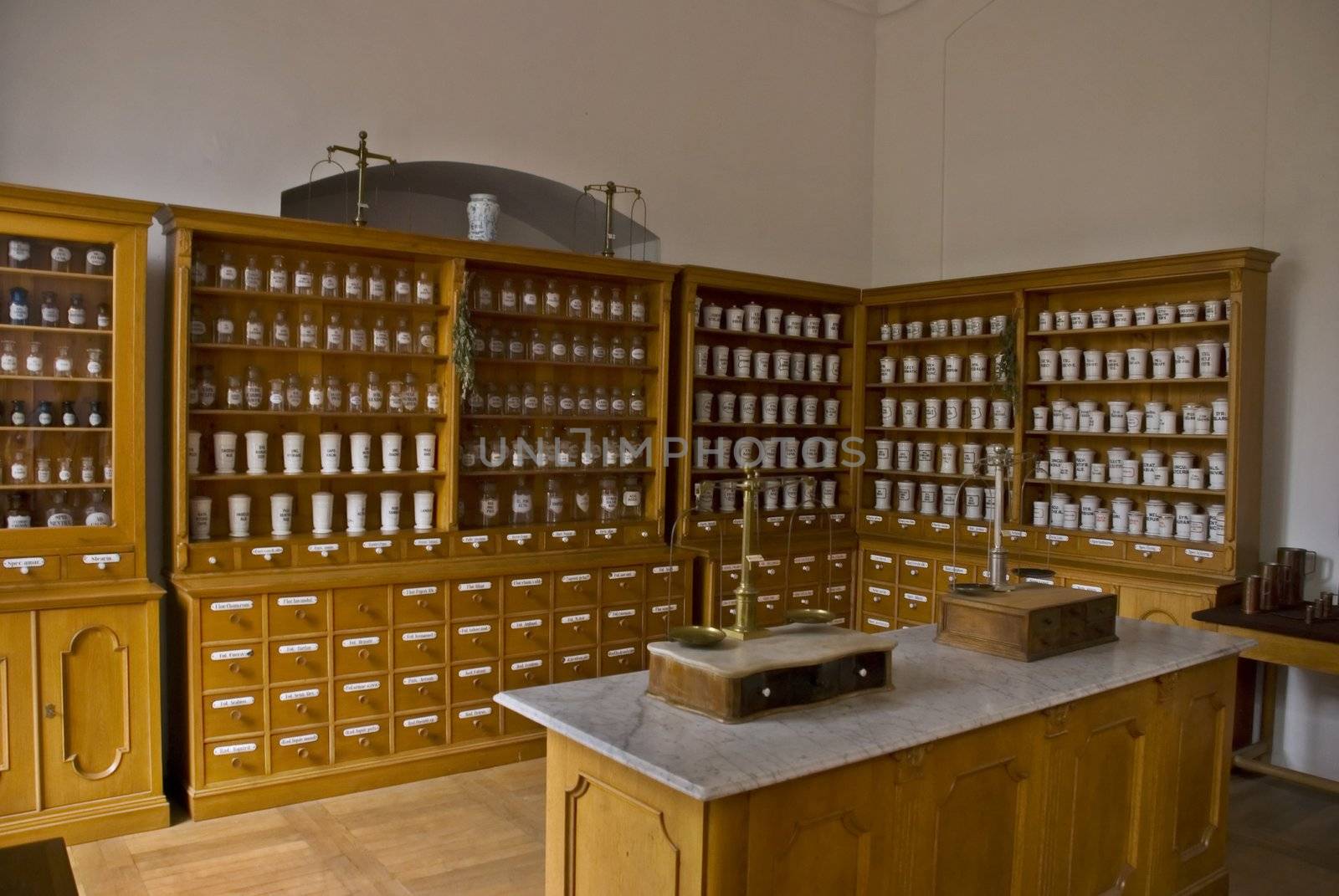 Medieval pharmacy with various pots, medicaments and scales 
