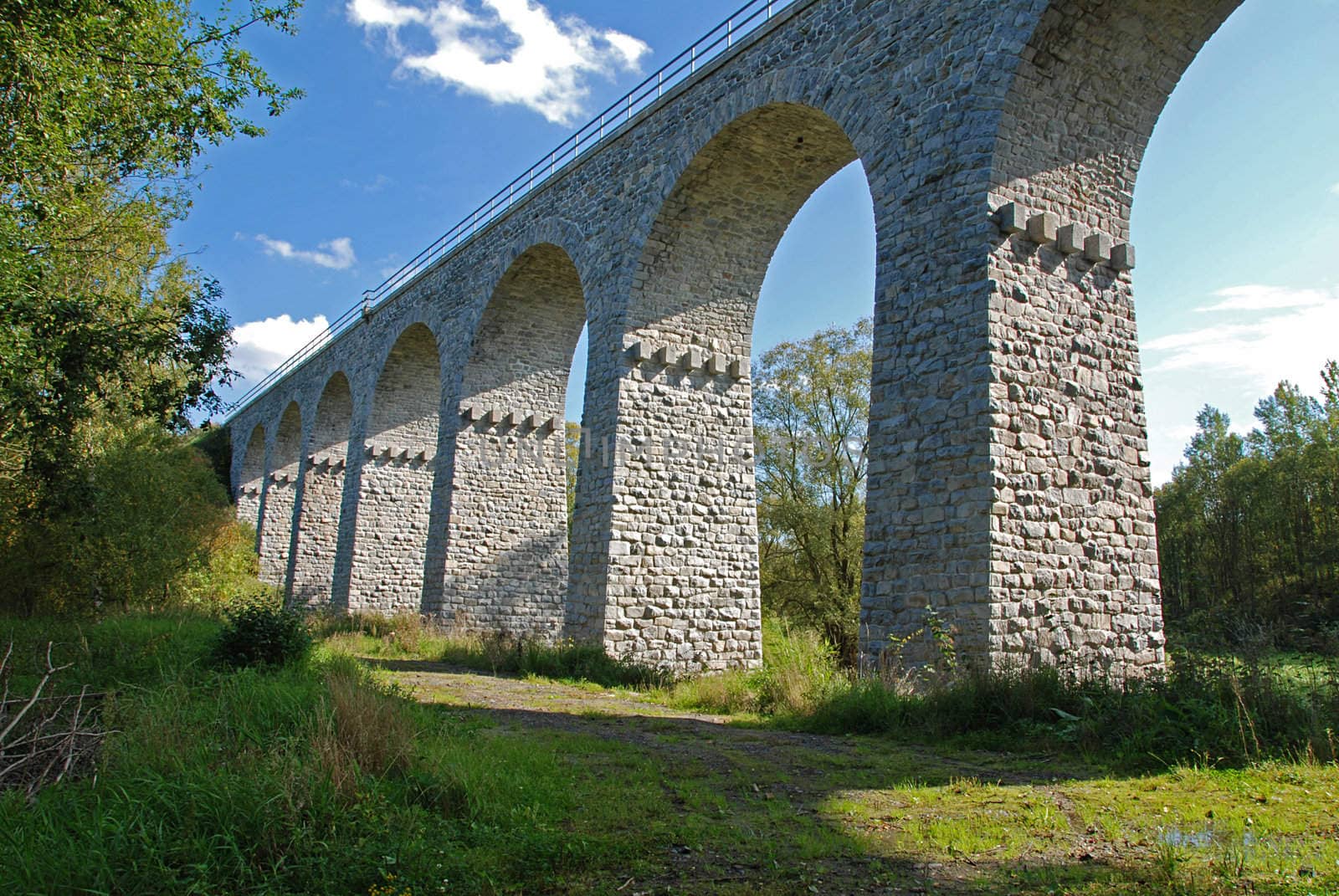 Old stone railway bridge with many bows