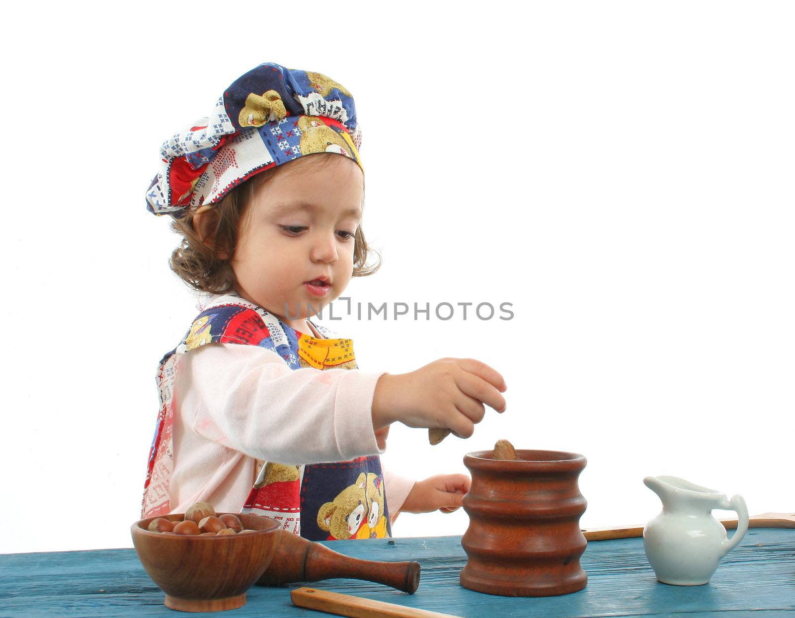 Little girl cooking dressed at a cheff by Erdosain