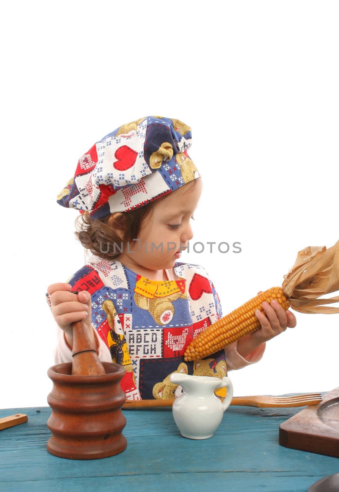 Little girl cooking dressed at a cheff by Erdosain