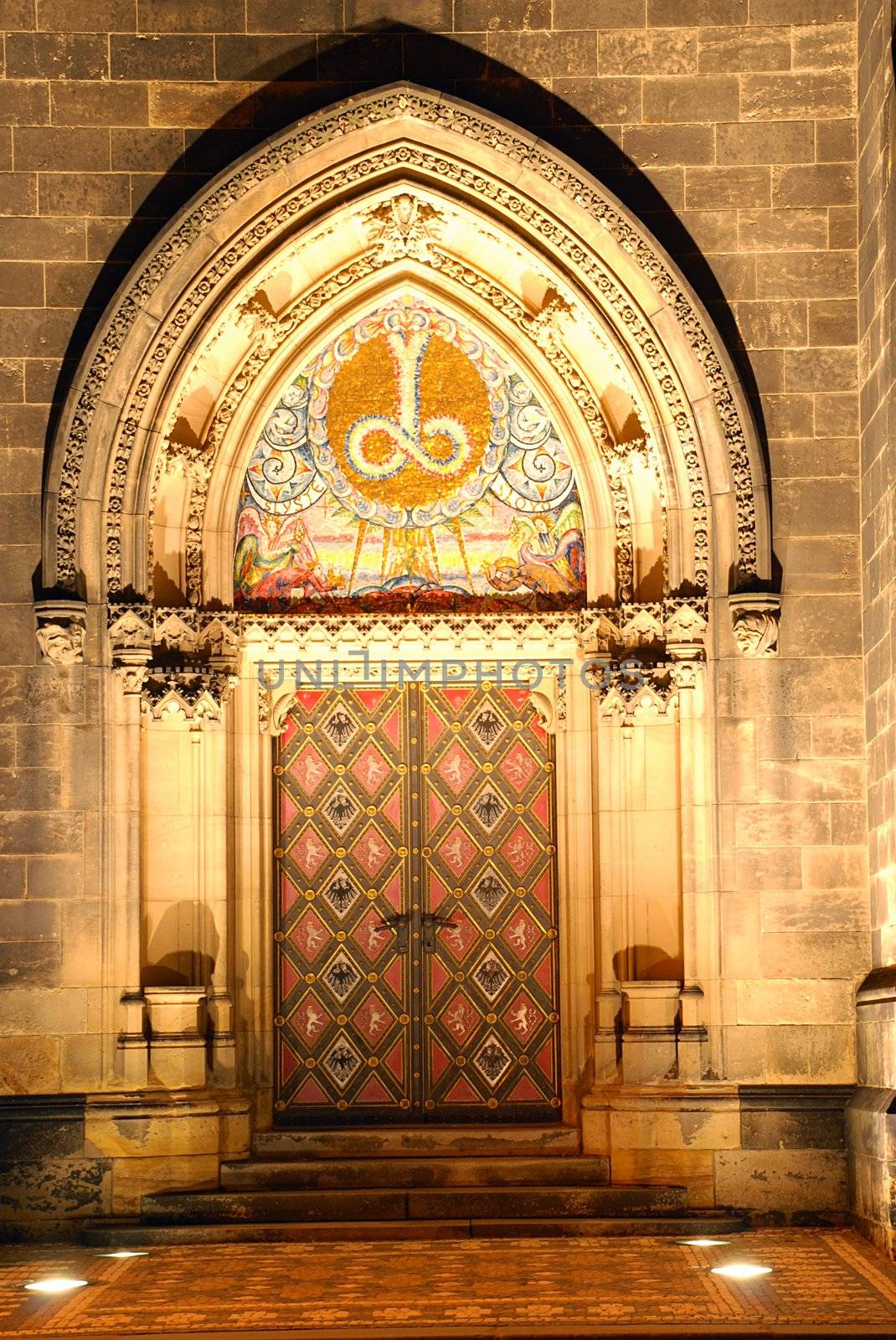 Illuminated portal of a czech cathedral on Vysehrad in the night