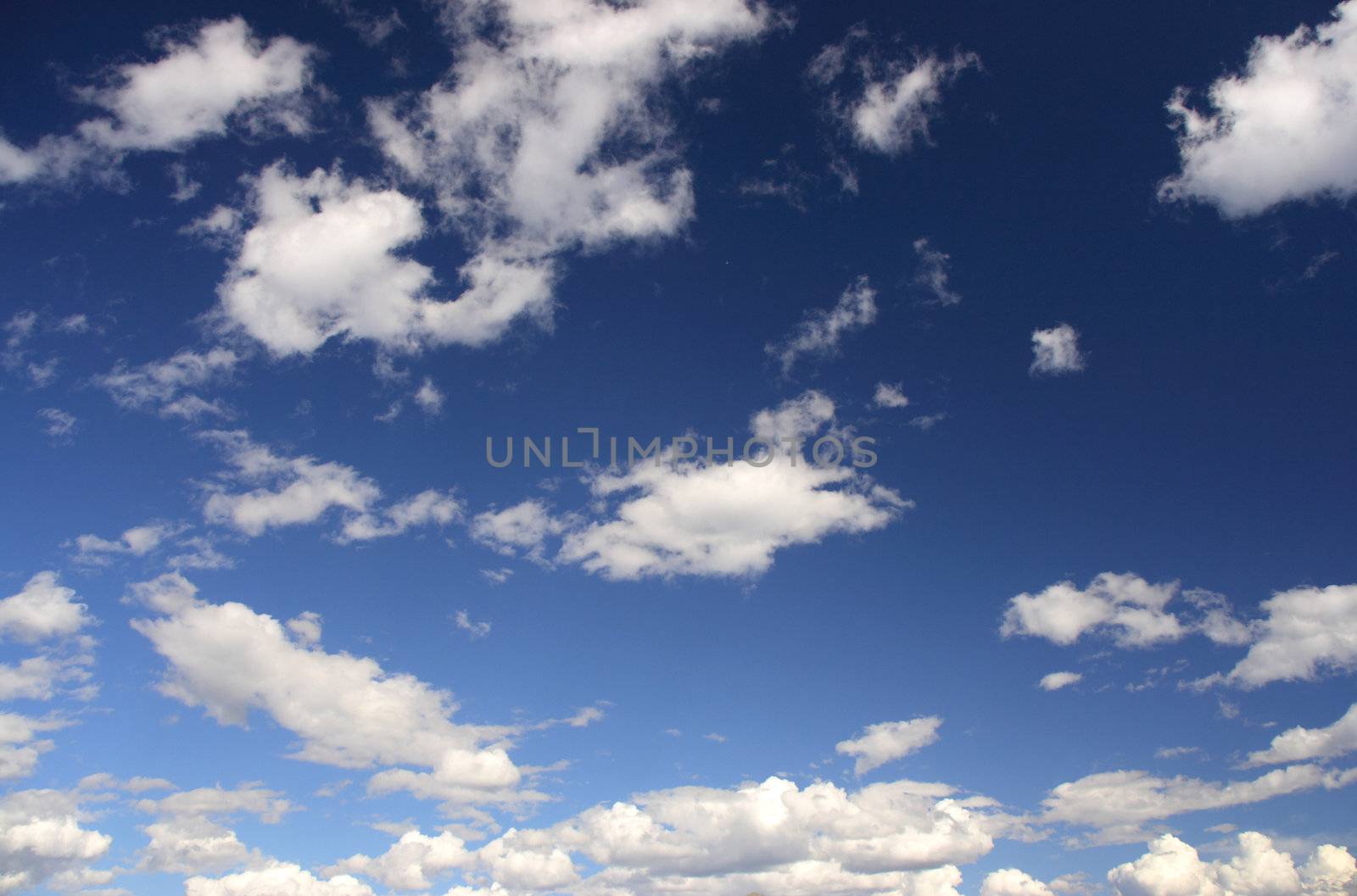 Beautiful white clouds on the blue sky. Abstract background.
