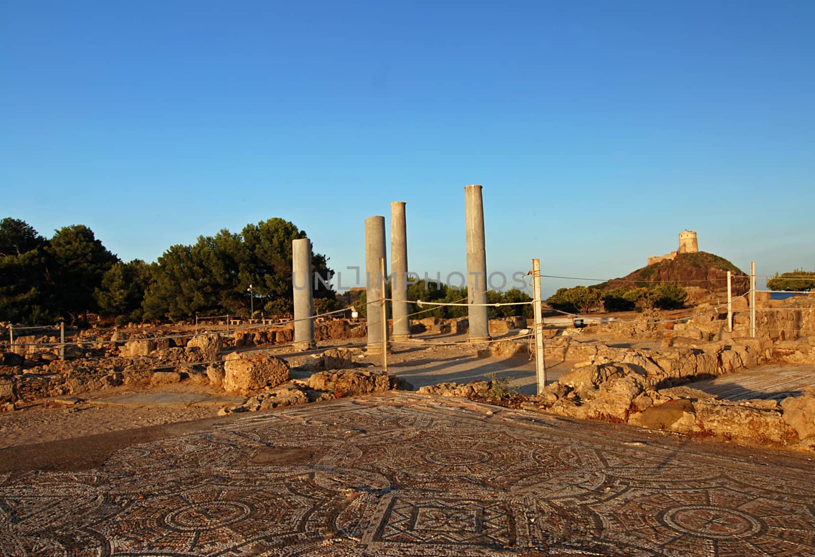 Ancient Sardinian ruins of Nora with sea and lighthouse