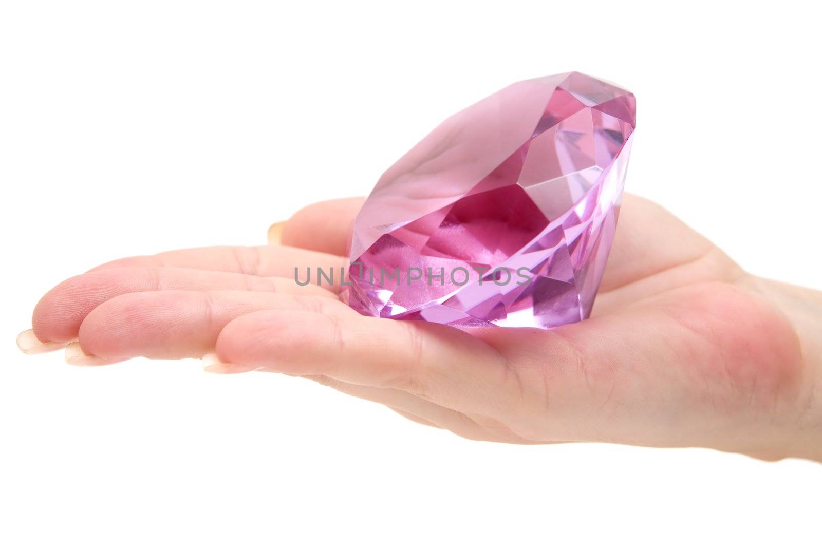 Woman holding a pink gemstone. Isolated on a white background.