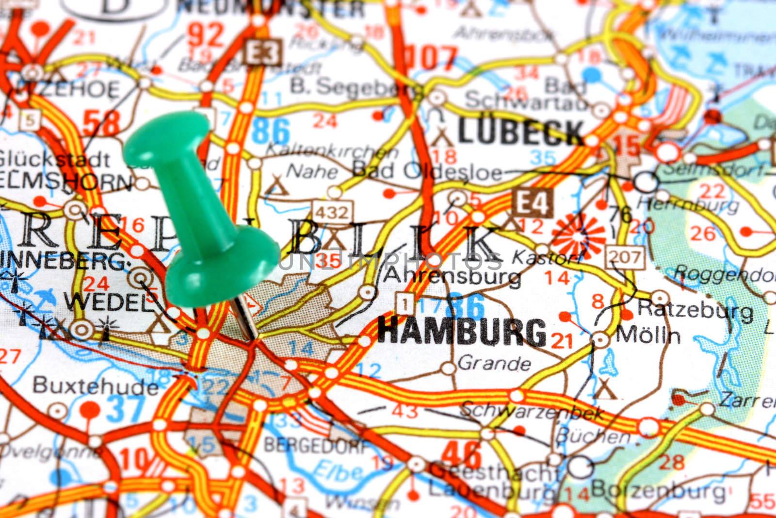 Hamburg, Germany, Europe. Push pin on an old map showing travel destination. Selective focus.