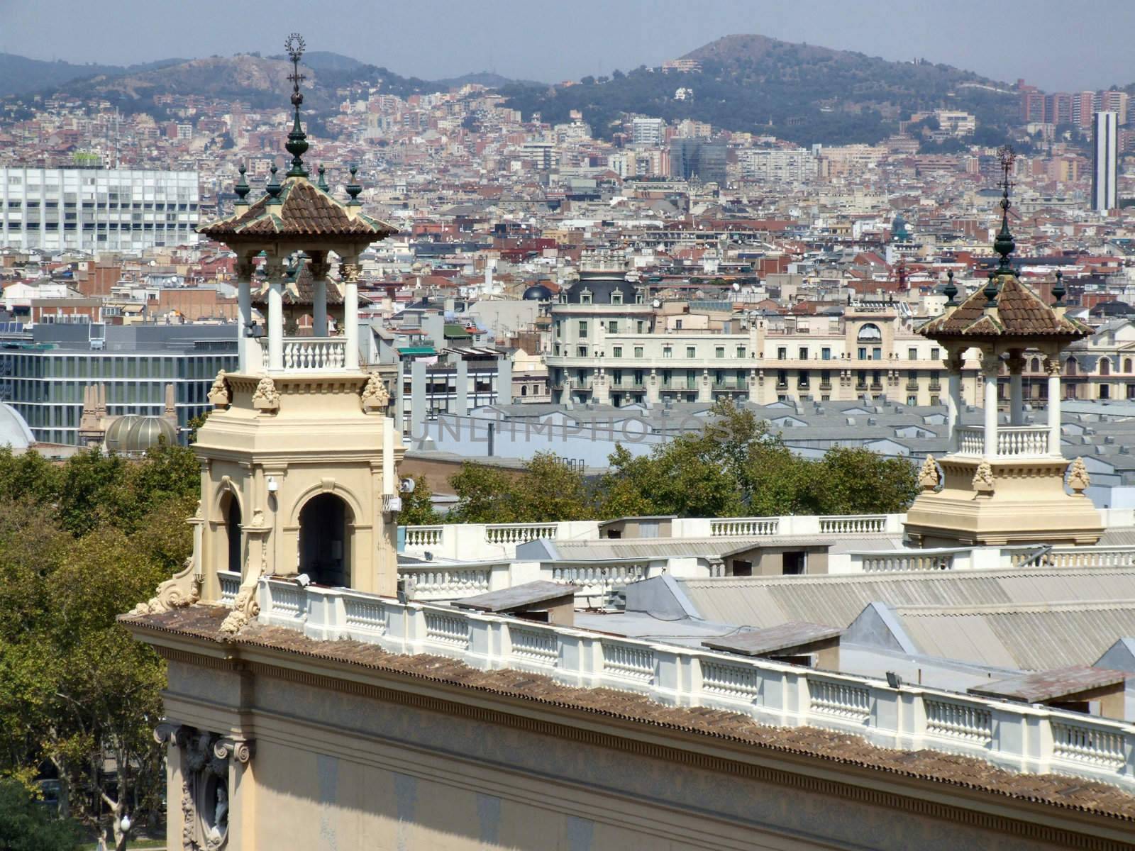 Barcelona landmark. In the foreground - towers of Palau Nacional, background is the cityscape of Catalonia capital city.