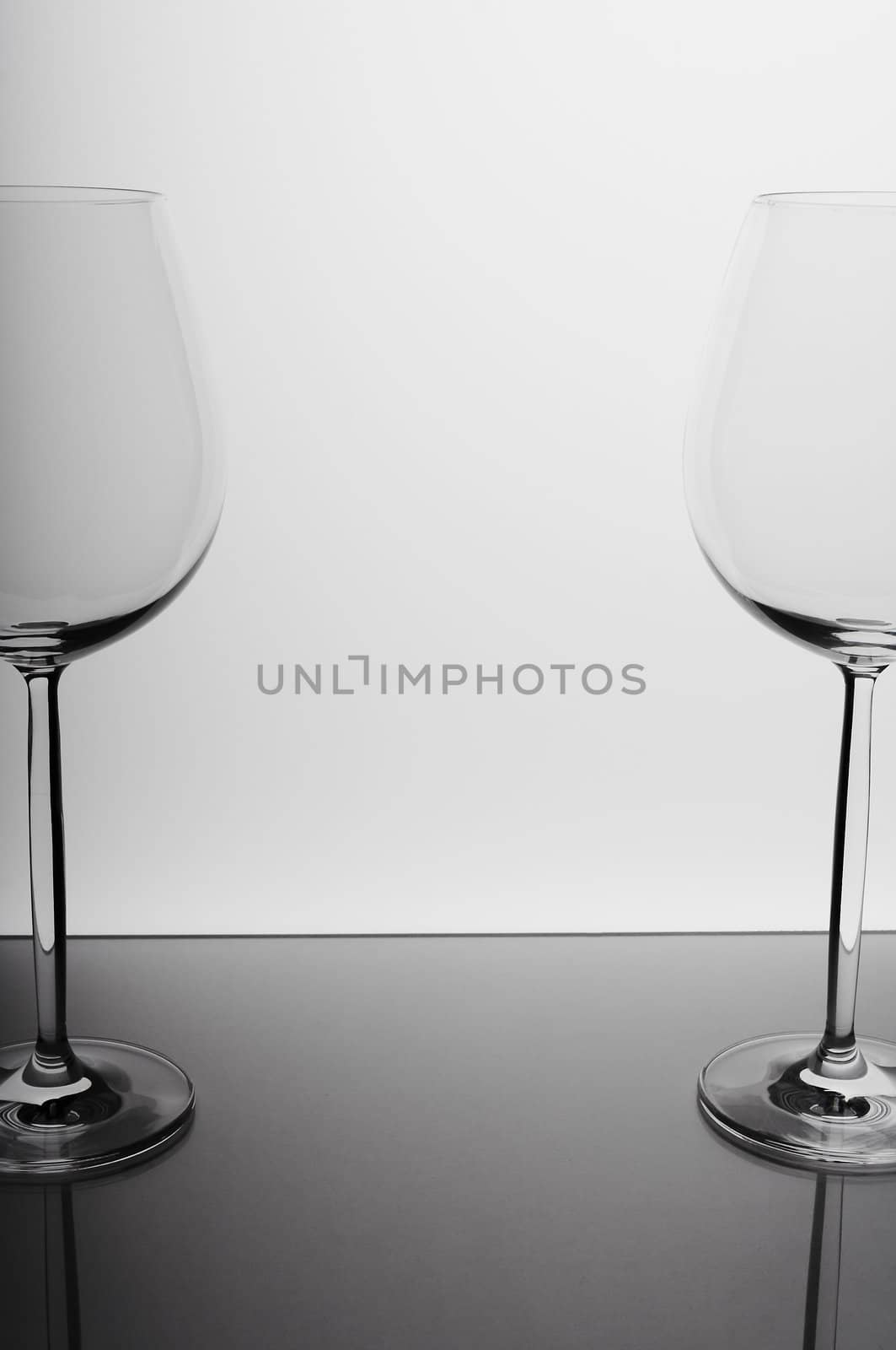 Two wine glasses against white background