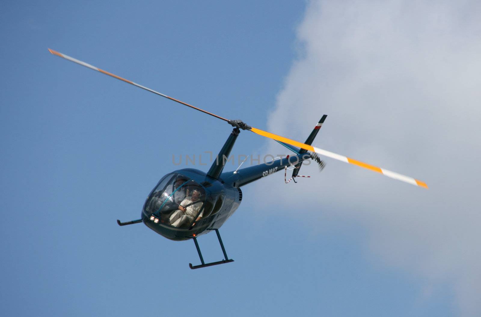 Private dark blue light helicopter on a sunny day. Aviation photo.