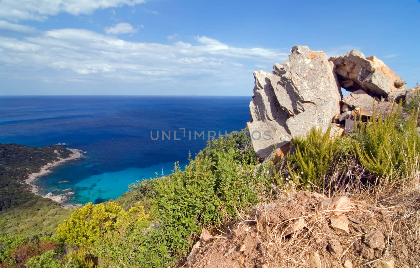 Blue lagoon with mighty rock on Sardinia island