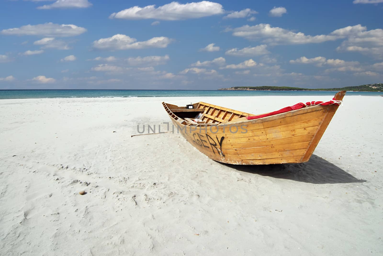 Wooden fishing boat on the white beach