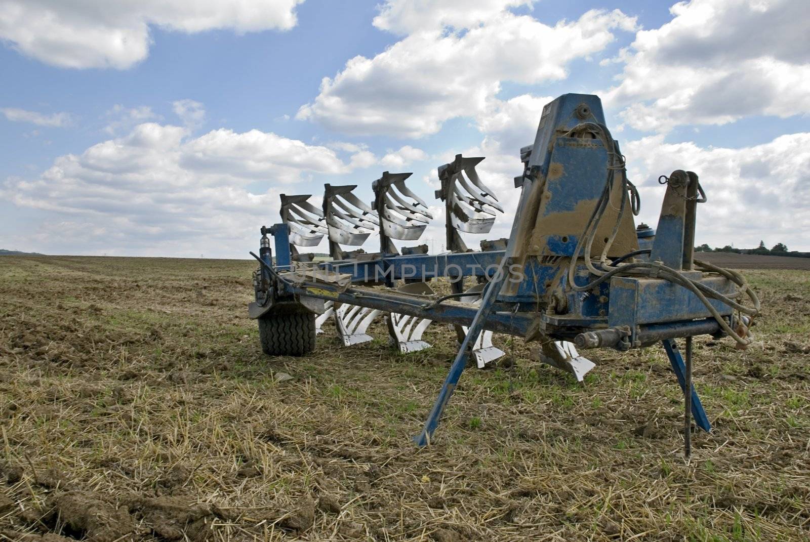 Plow in the field after the harvest