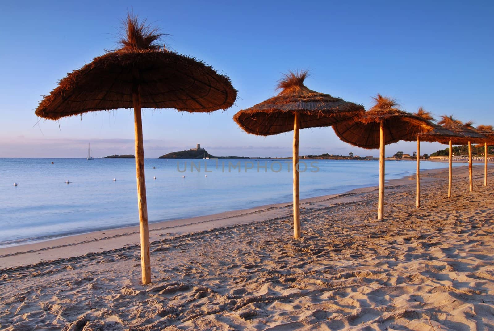 Ubrellas on the empty beach early morning