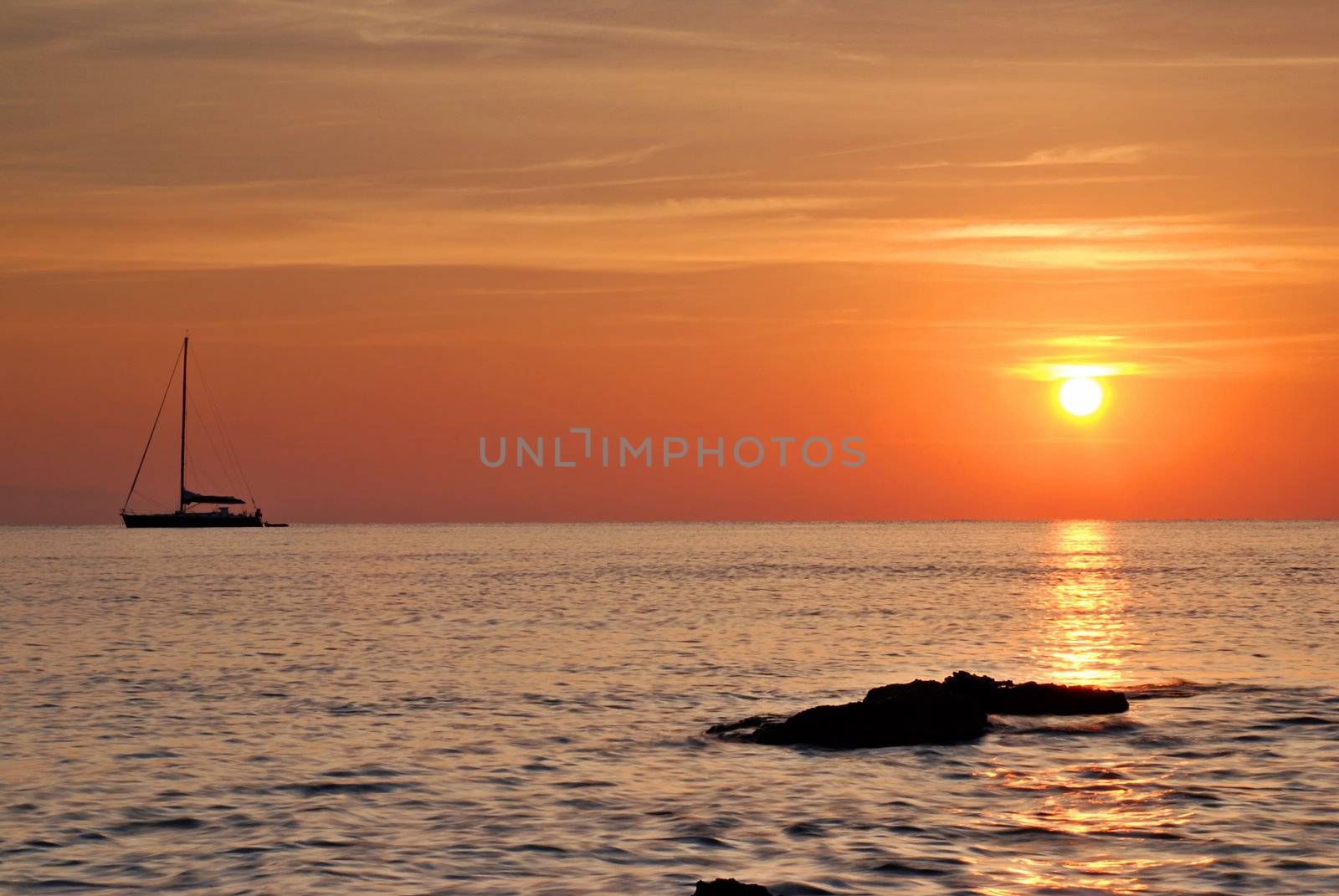 Sailing boat silhouette and  sunrise
