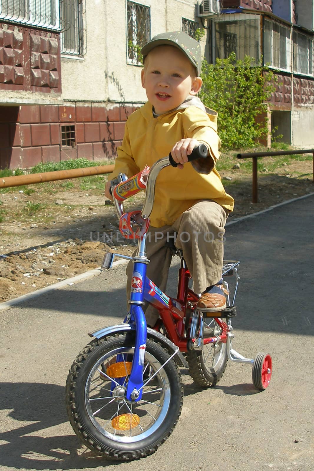 The boy goes for a drive on a bicycle