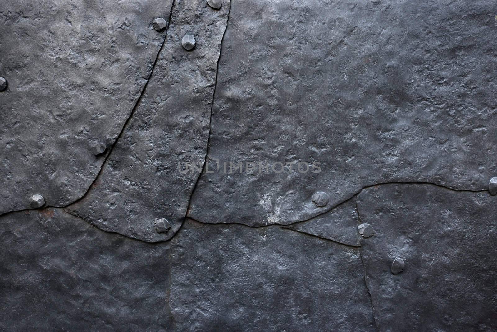 Background/industrial image of hammered metal plates with old rivets.
