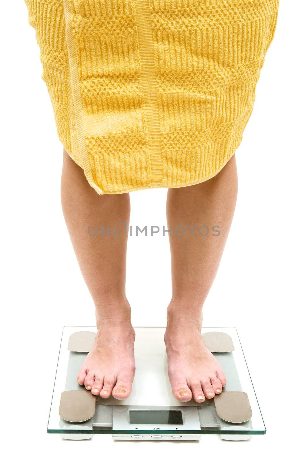 Woman standing on a bathroom scale. Isolated on a white background.