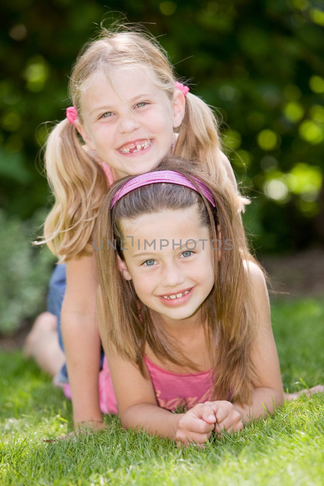 Two young girls having fun together outdoors