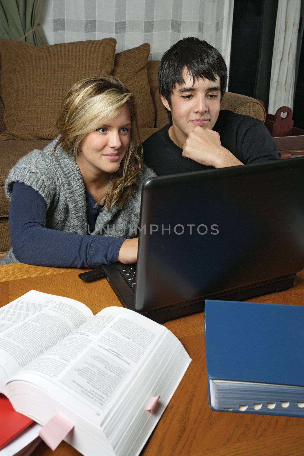 Students doing homework with laptop by sumners
