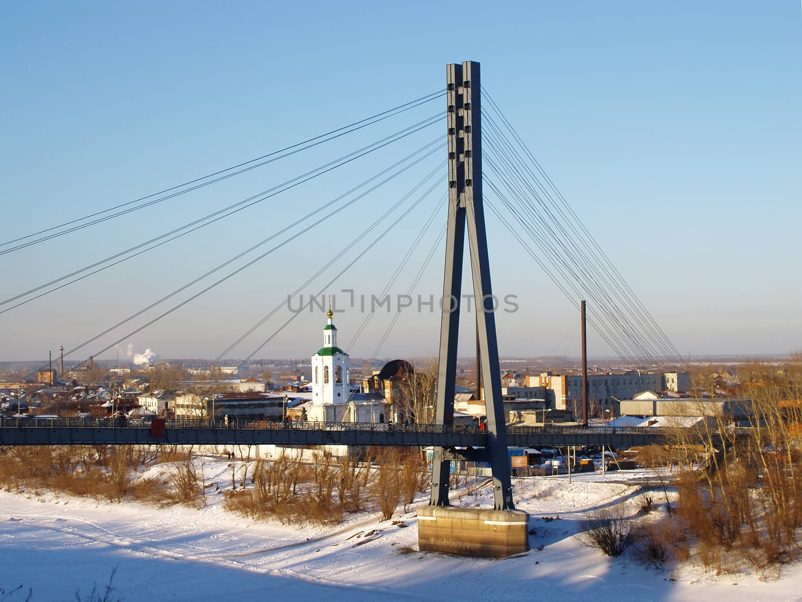 The foot bridge through the Tura river. The city of Tyumen
