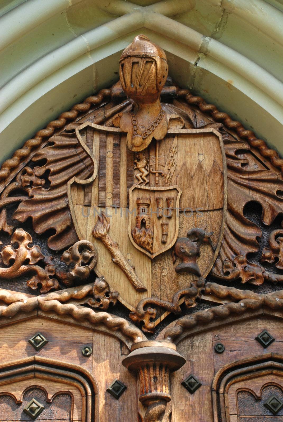 Door carving with medieval knight coat-of-arms