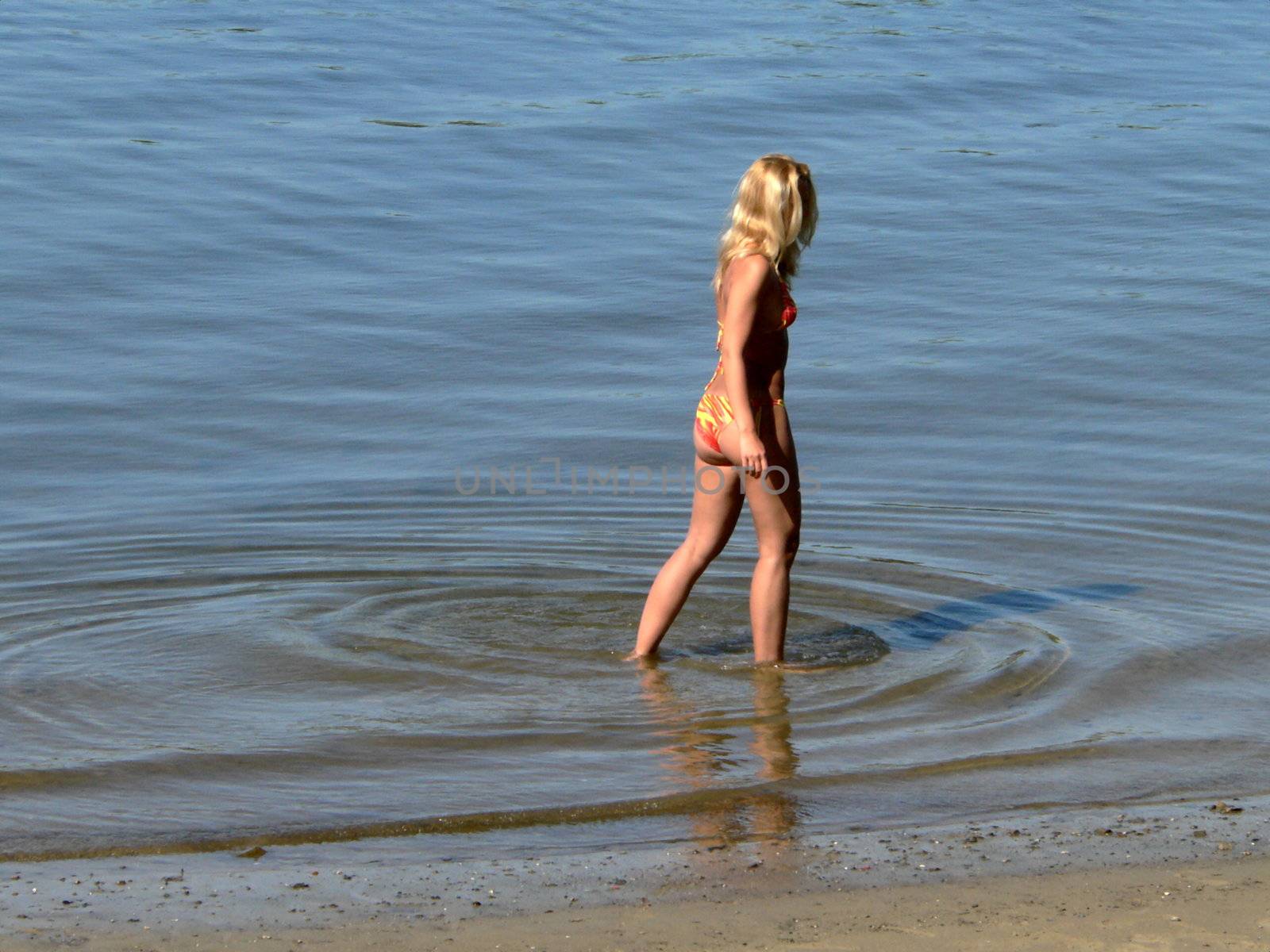 Young girl enter into the rivers water 3