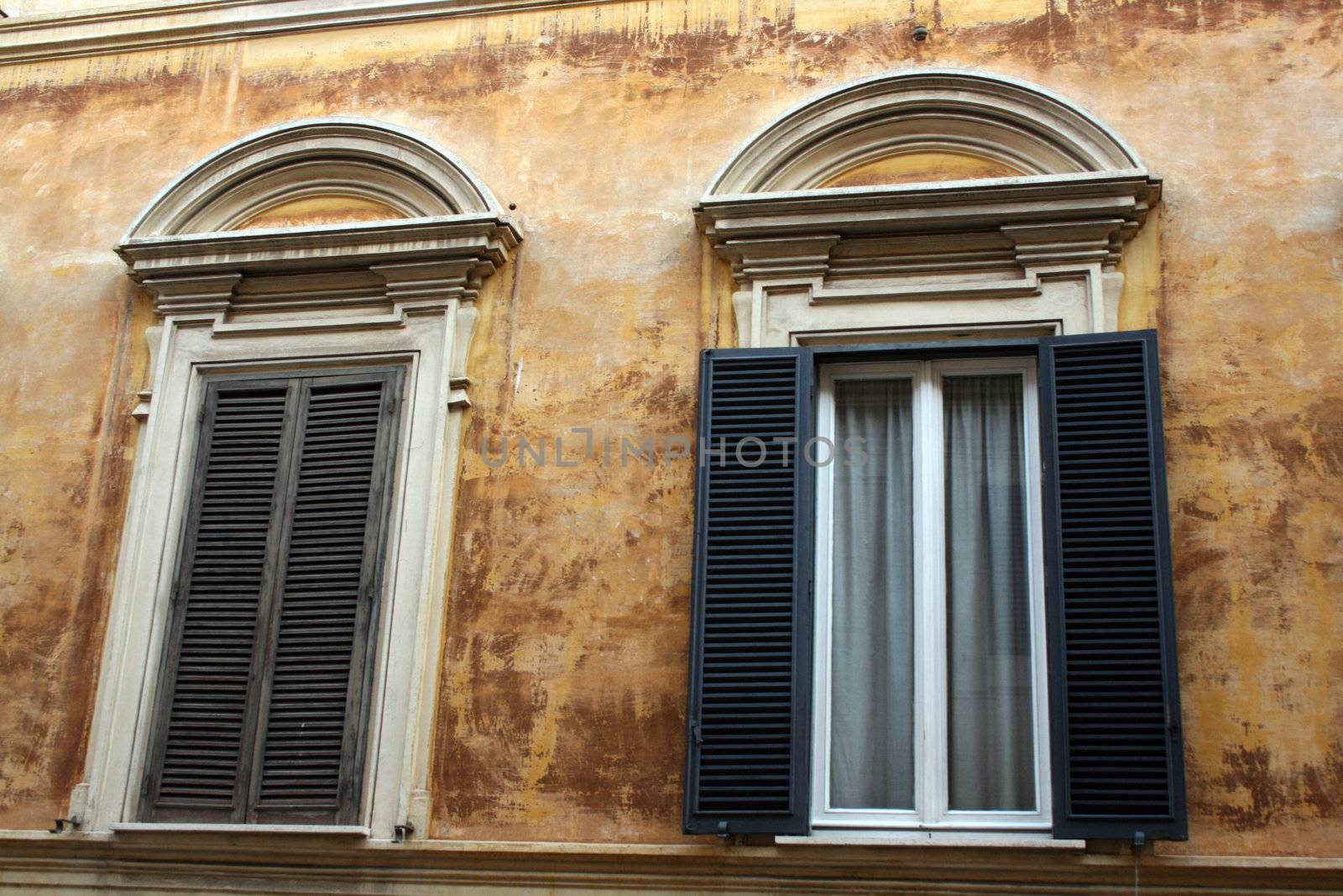 two roman windows, one open one closed