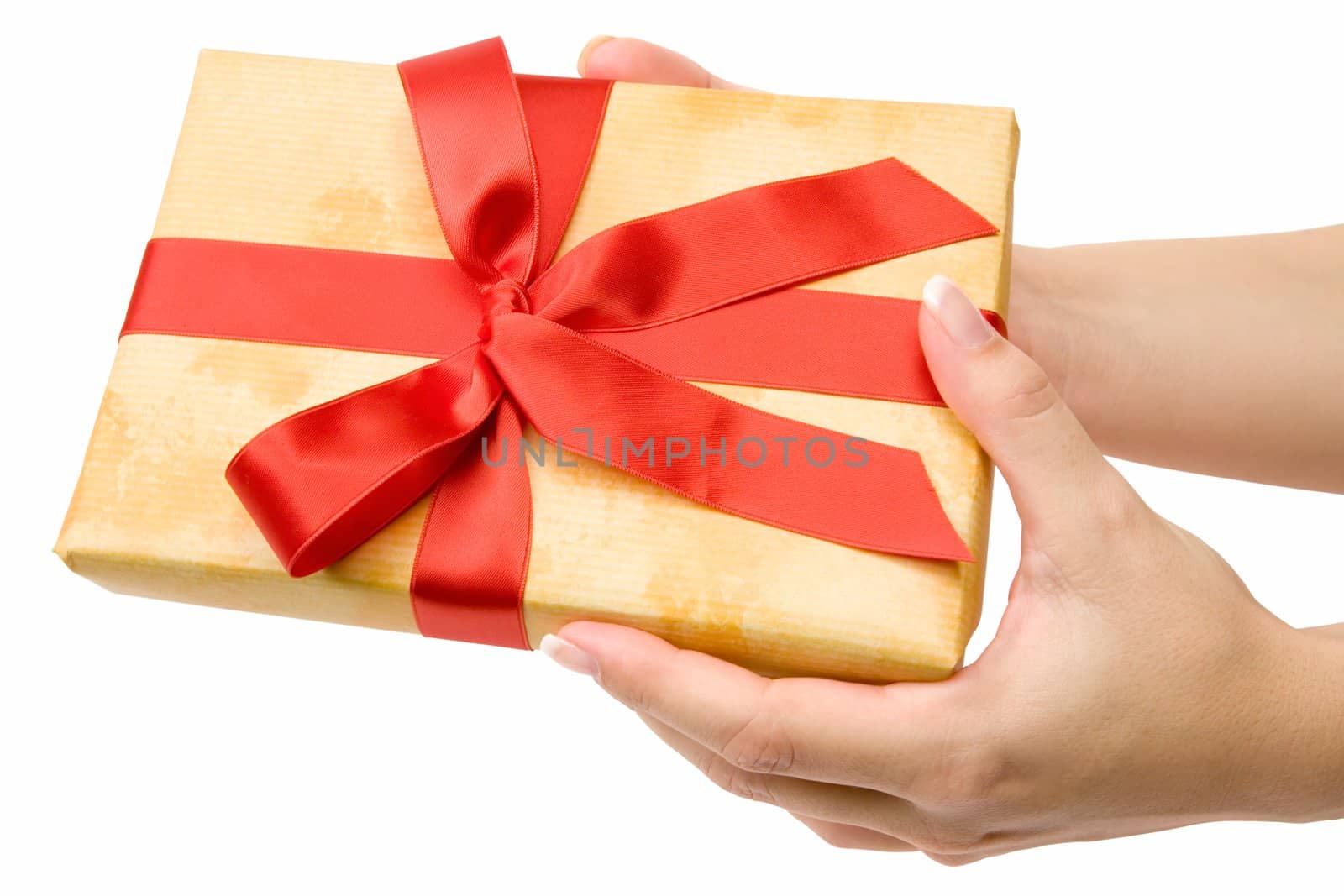 Female hand holding an ornamented gift. Isolated on a white background.