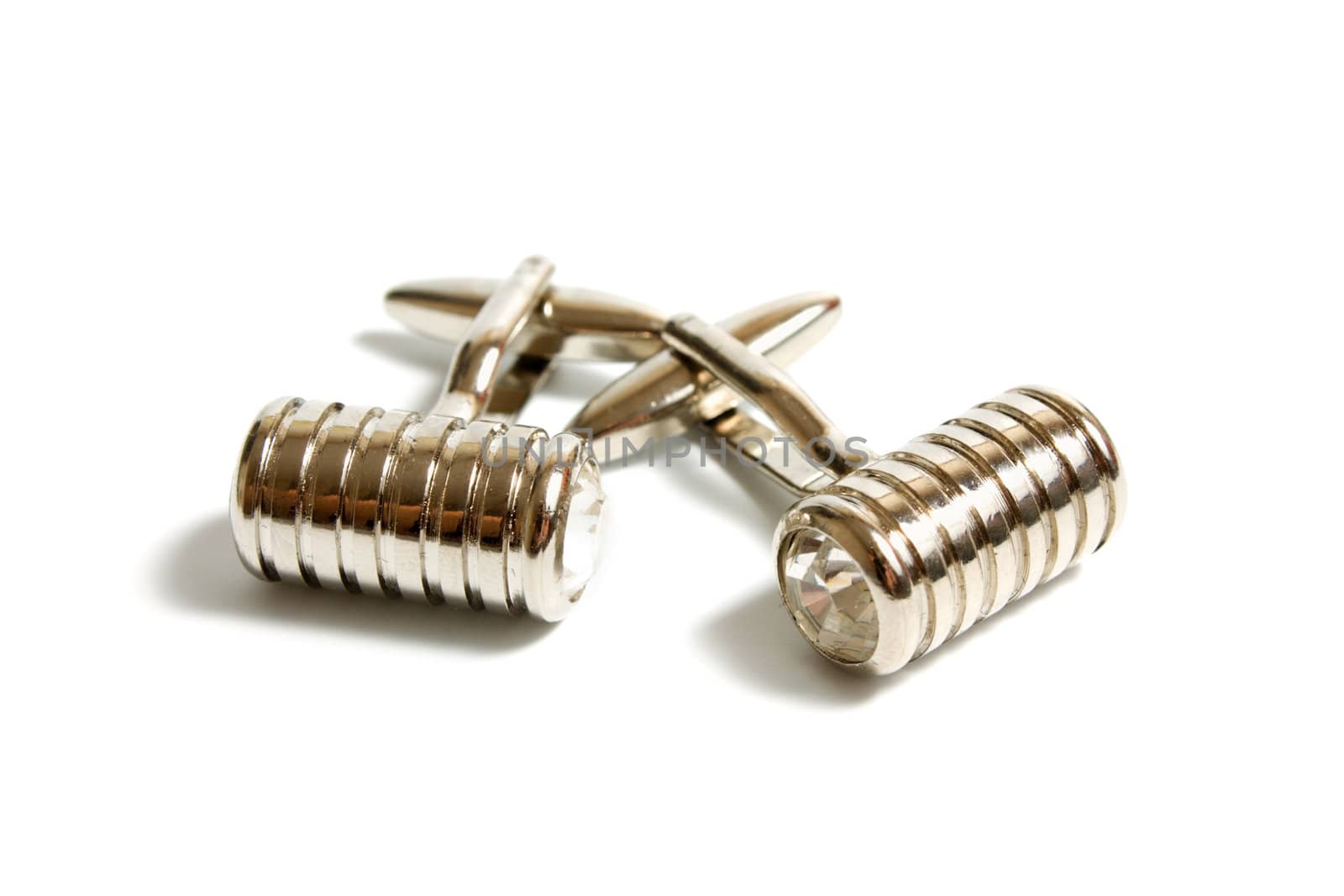 a pair of stainless steel cufflinks on white