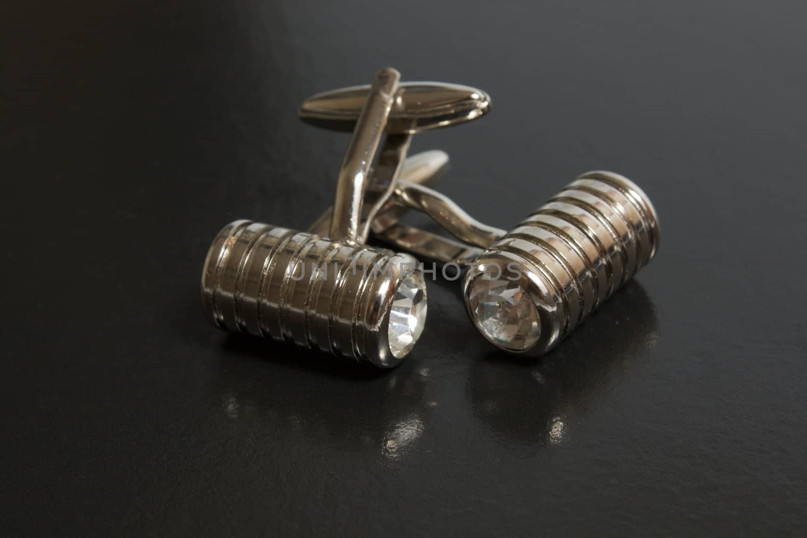 stainless steel cufflinks on the black background