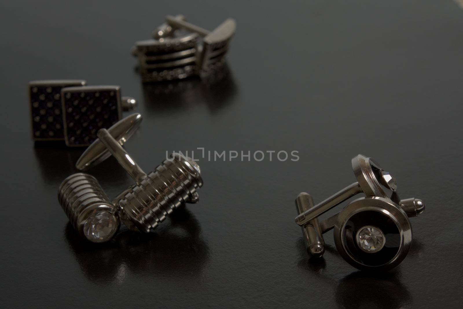 stainless steel cufflinks on the black background