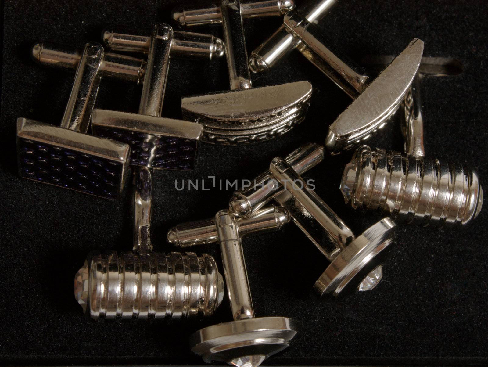 stainless steel cufflinks on the black background