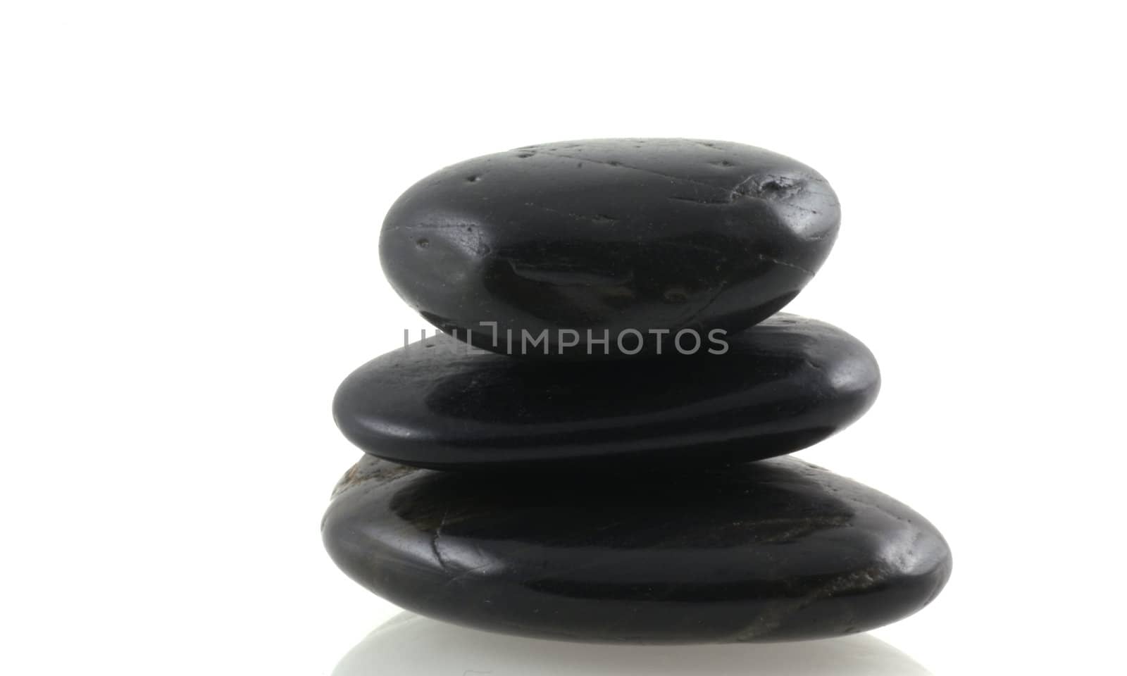 Pile of black stones on a white background.