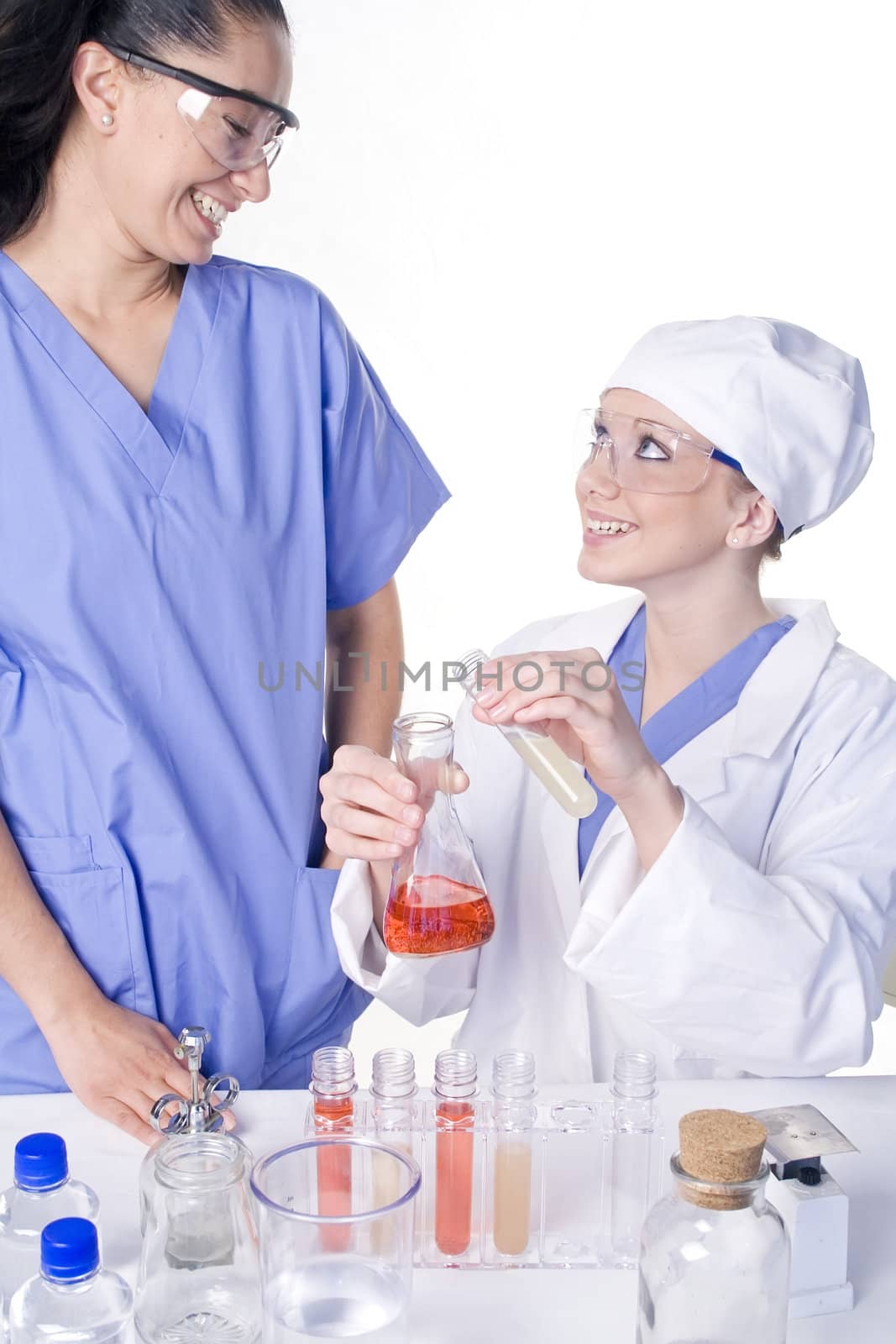 Young scientist in laboratory with test tubes and chemicals