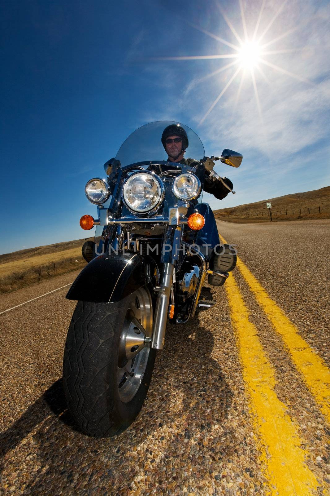 A biker enjoying a ride in the country side on a sunny day