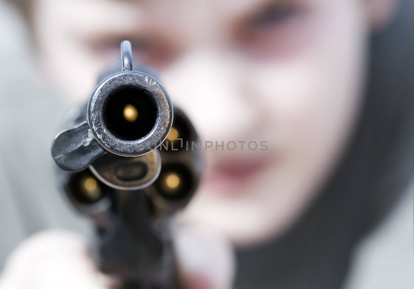 Loaded gun aimed at you, focus on gun barrel (shallow dof)