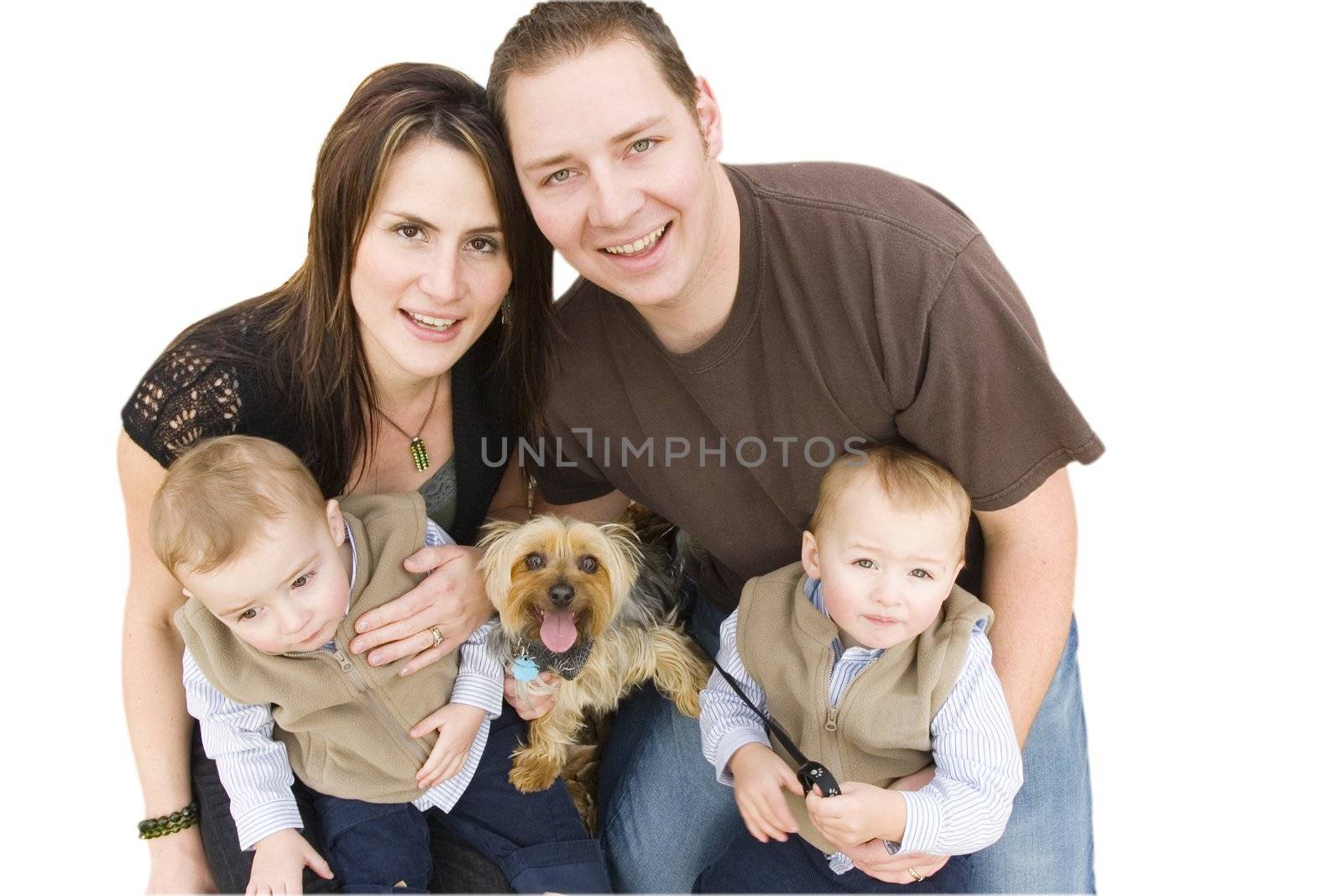 Young family with twin boys and a dog looking up 