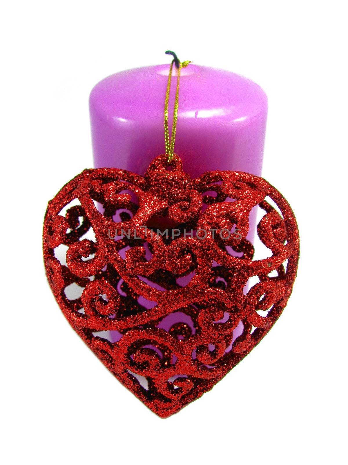 Violet candle with a red heart with a filigree attached to the Valentine's Day