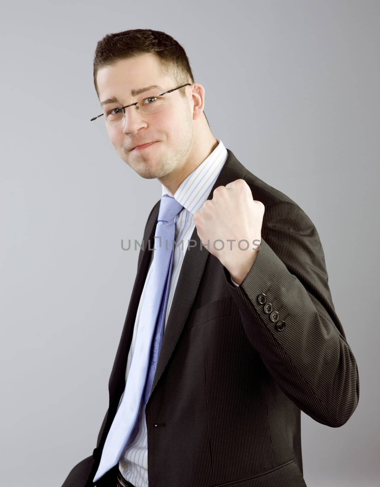 Portrait of young man in business clothes expressing satisfaction