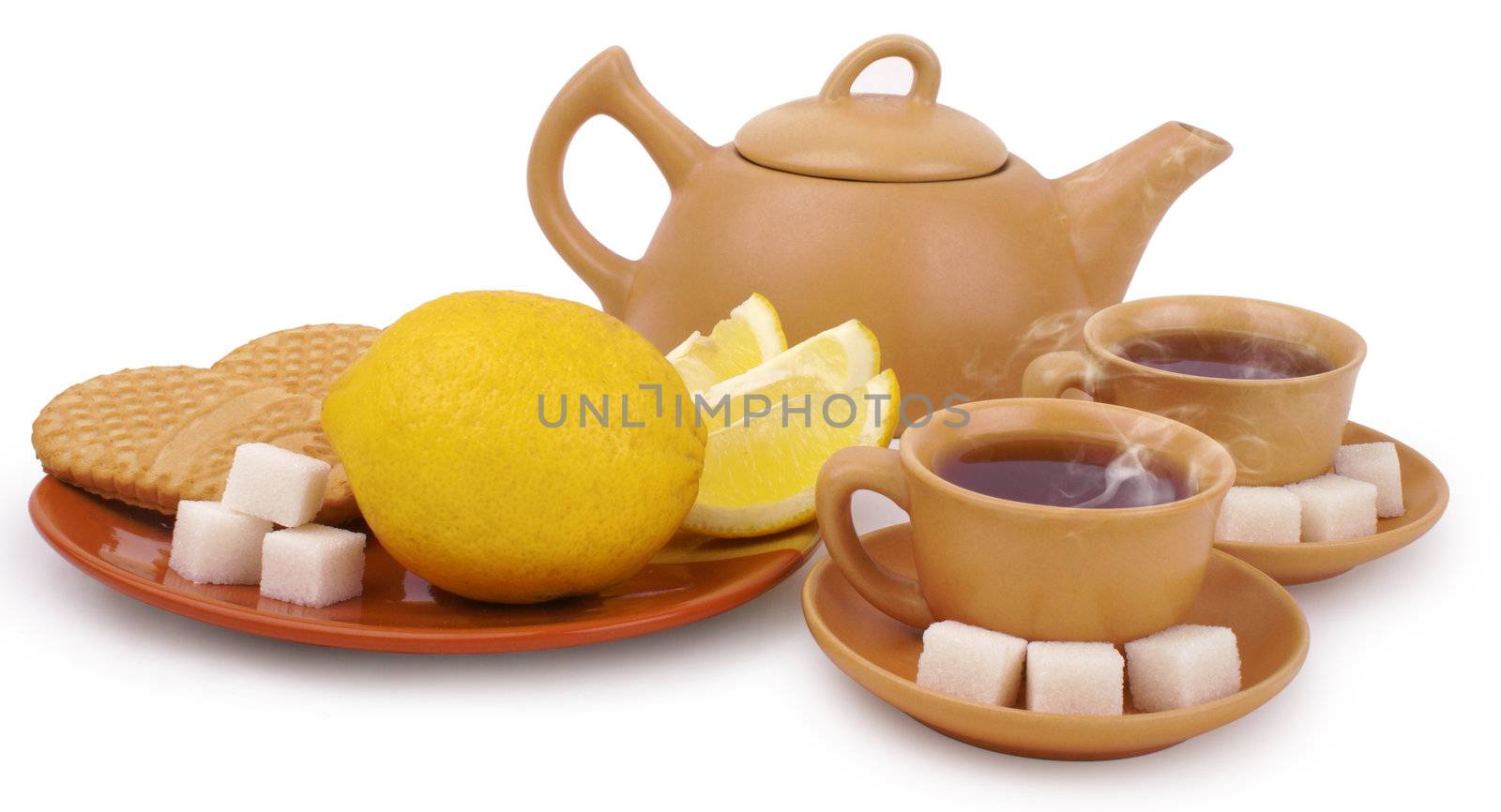 set of the earthenware teapot, two cups of tea, lump shugar, sliced lemon and biscuits isolated on white background with clipping path                        